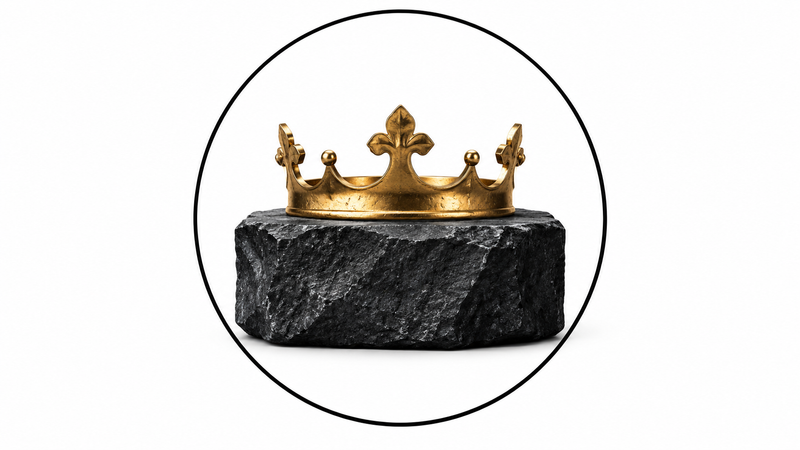 Wordless crown resting on charcoal stone, symbolizing power under submission