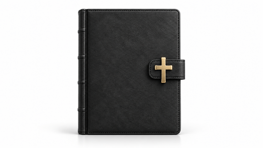 A closed charcoal journal with a gold cross clasp on white, symbolising reverence for holy commitments.
